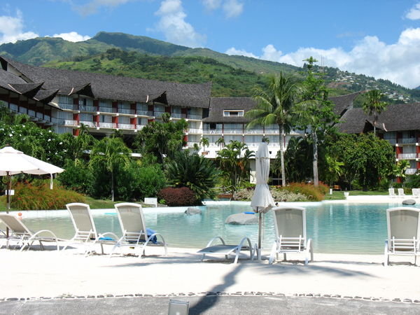 Hotel and pool with view of Tahiti in the background