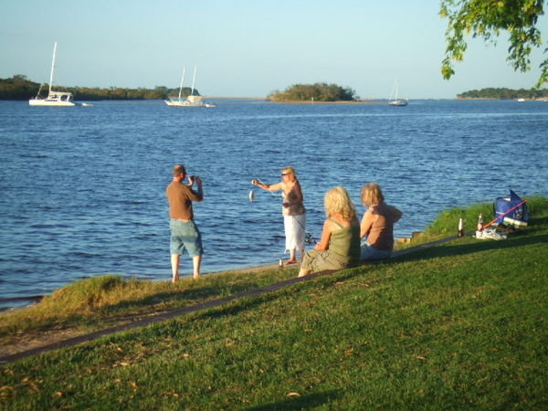 Family beside wide Noosa River