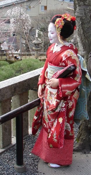 A Geisha visiting a hill top shrine