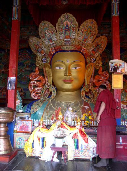 Old historic 5 meter tall statue of the Buddha standing tall inside a room at Thikse Gompa, Thikse