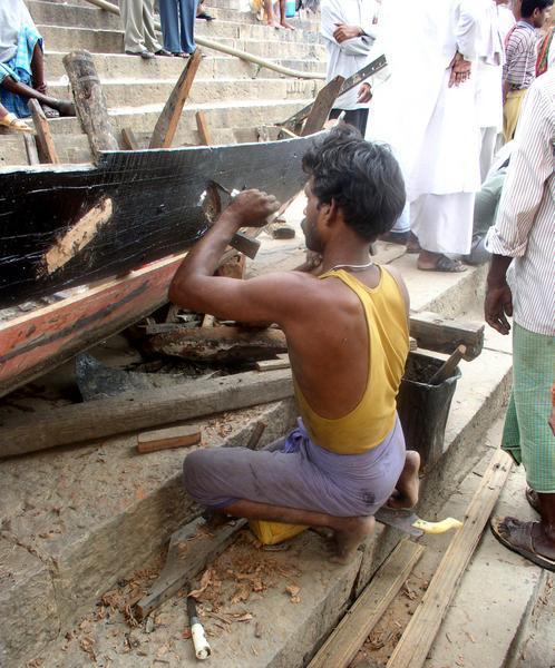 Carpenter repairs a boat, Varanasi