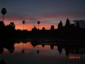 a magnificent sunrise begins over Angkor Wat