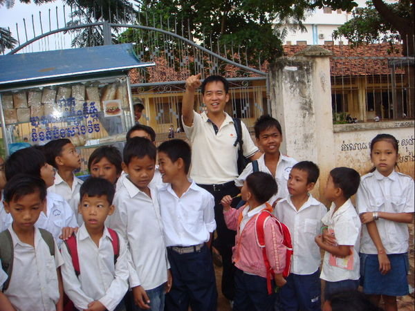 With a Group of Students Outside a School