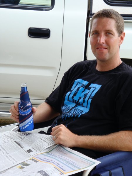 Brett happy to be back in the caravan and enjoying a brew in his Canucks beer cozie.