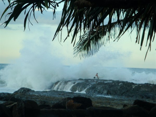Some of the huge waves crashing on the rocks and a surfer at Snapper