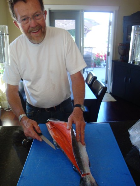 Brett's dad, Mike, prepping another salmon for dinner