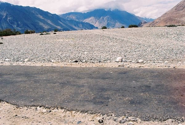 Road on a dried up river bed before hitting Diskit in Nubra valley