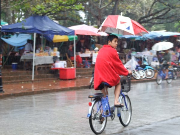 Locals riding with umbrella