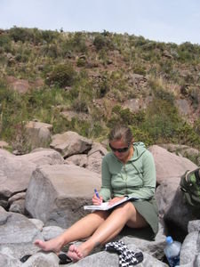 Writing postcards on a rocky shore of Lake Titicaca.