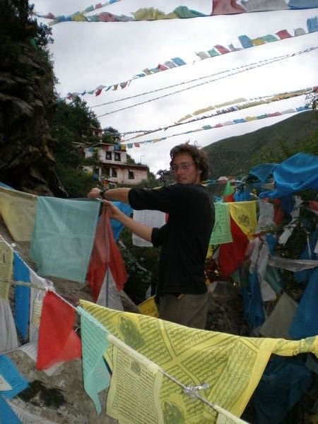 Fred ties up prayerflags, hermitage near Samye Monastery