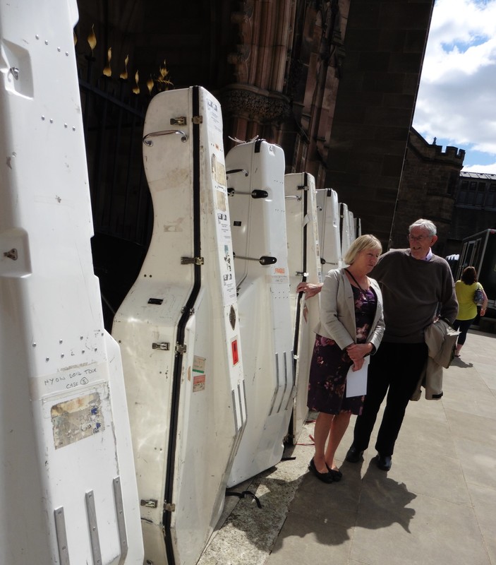 row of double bass cases left outside
