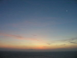 Sunrise with the moon in the upper right
