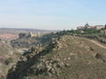 The mountain side surrounding Toledo with a castle in the distance
