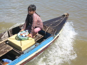 Selling wares in Floating Village, Cambodia
