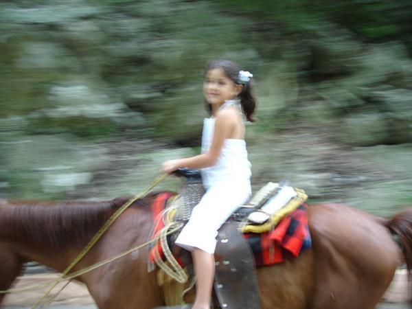 girl riding horse and posing for us