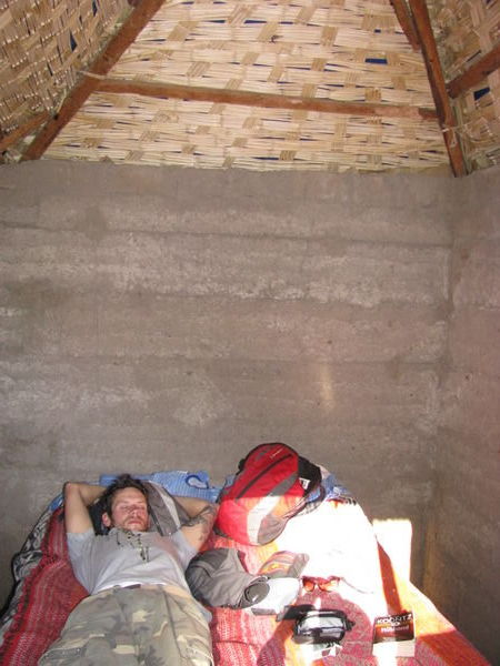 Dale asleep in our mud hut