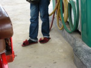 Slippers on the petrol pump attendant
