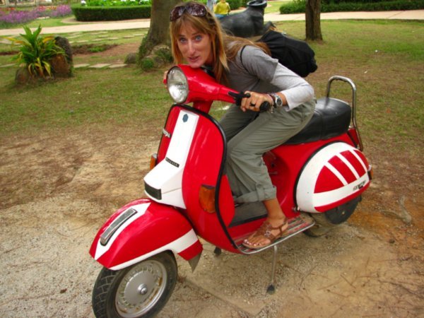 Sophie on a moped in the Valley of LOve