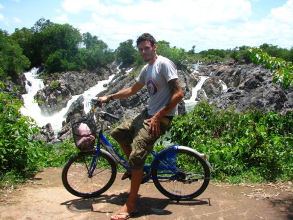 Dale on bike at the waterfall