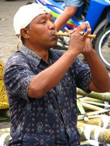 Man playing a flute in the market
