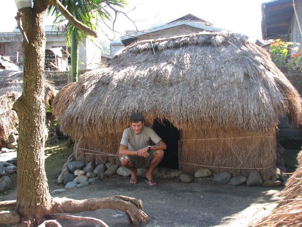 Dale outside a hut