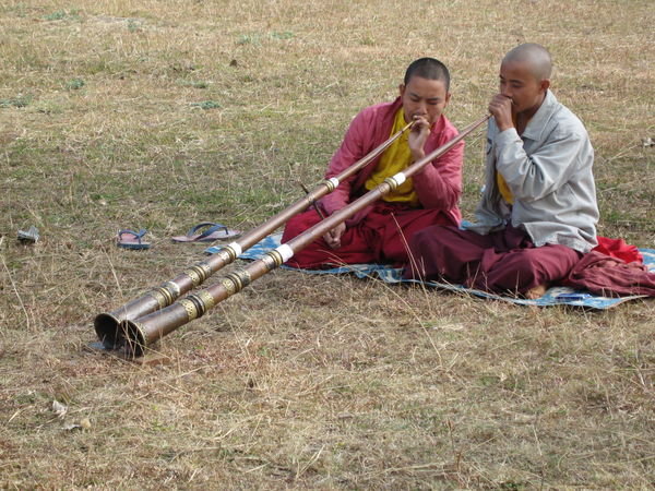 Monks playing horns