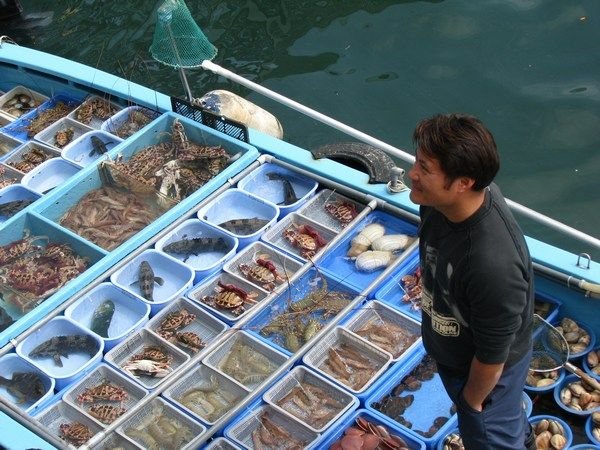 Fisherman selling his catch at Sai Kung