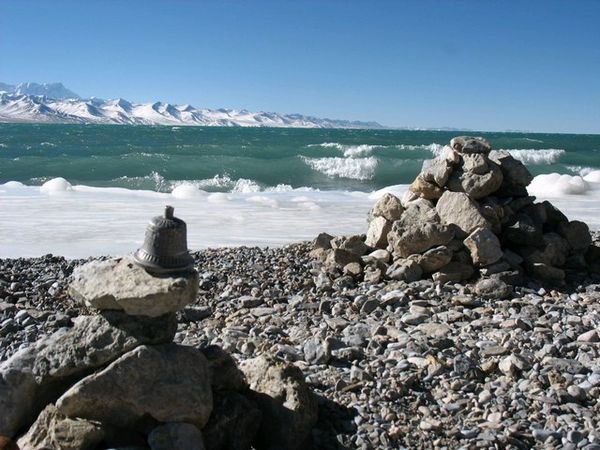 An old bell on top of a cairn by the shore of Namtso Lake