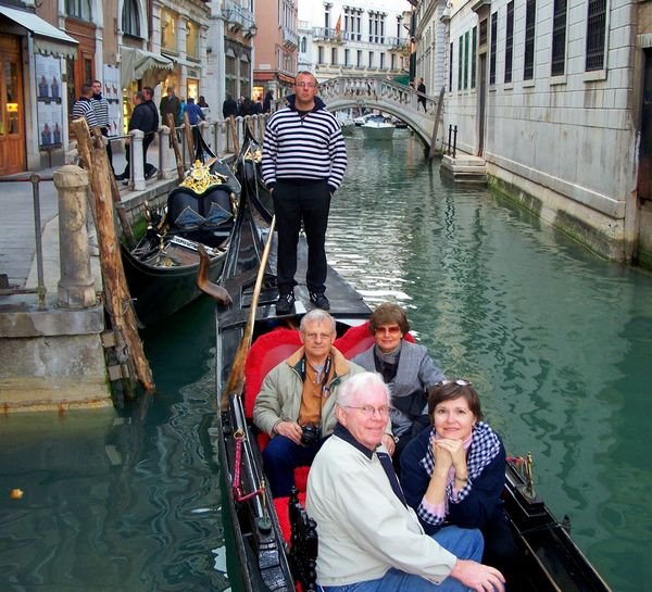 The four of us on a gondola ride on the canals of Venice