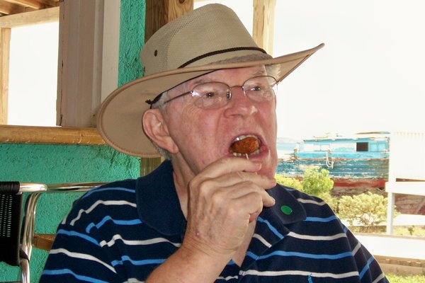 Bill enjoys a conch fritter at the Bare Naked Conch cafe