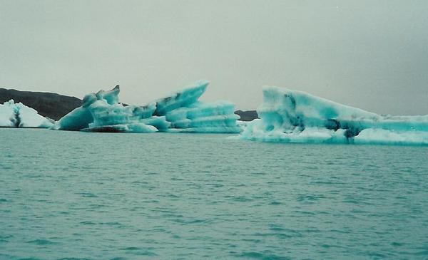 Boat ride among the icebergs surrounding a glacier