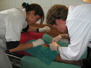 a student and me doing a sewing at a patient