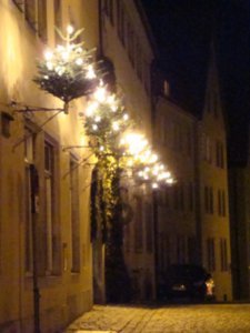 little lit trees were mounted on the buildings all over town