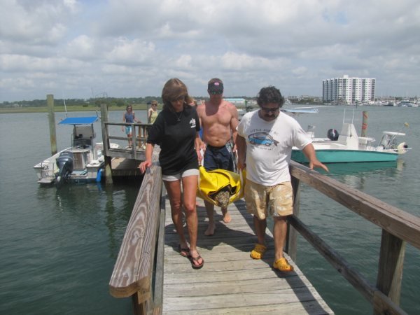 2010, carried by Nancy the sea turtle project coordinator, and his saviors, Dave and Carlyle.