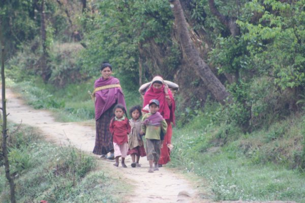 Village family carrying their goods in baskets