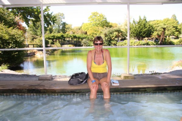 Ahhhhh, that feels so good. C Soaking her feet in the hot pool in the park, Rotorua
