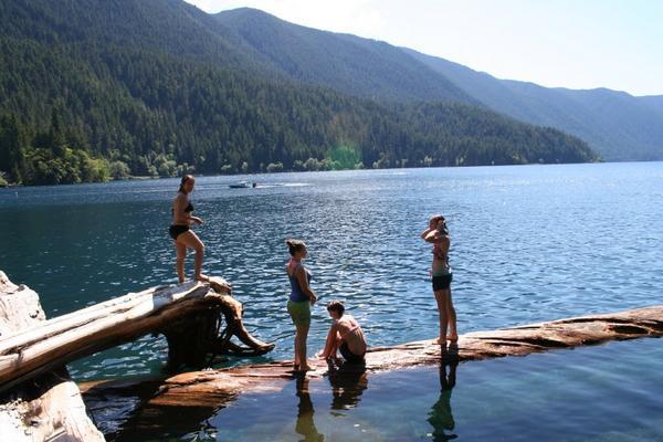 Jumping off logs at Lake Crescent, Washington
