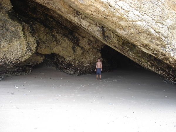 Chris standing at the front of a cave