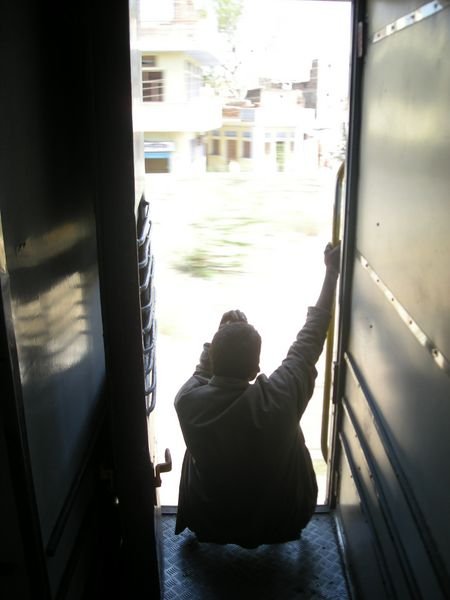 Indian man staring out the door