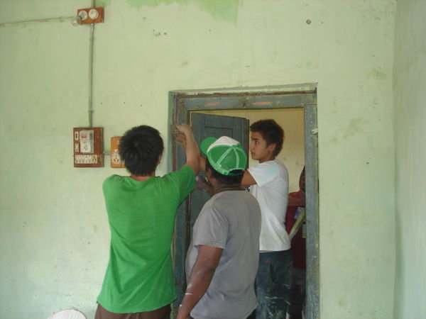 Evan, Koishiro and Joy fixing the door