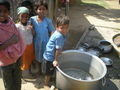 Some children beside the orphanage rice pot