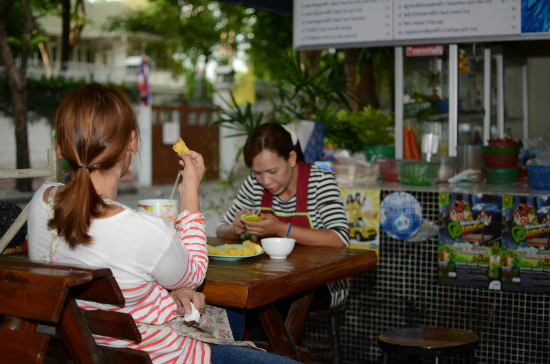 Thai ladies eating pinaple with salt