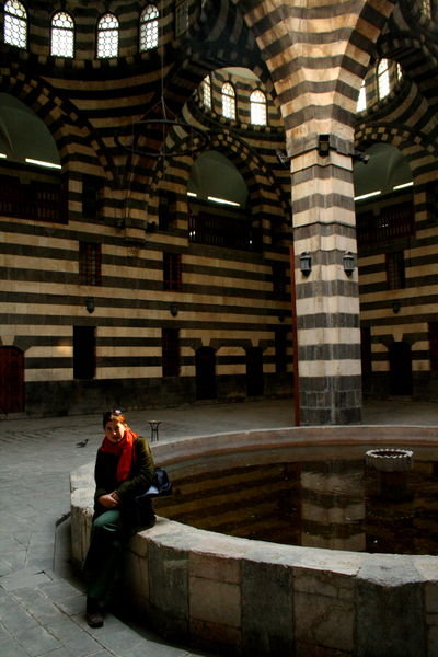 In the zebra-striped marble kahn among the souqs of Damascus