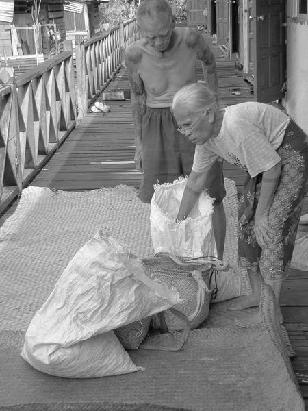An Old Iban Couple Preparing Nuts for Drying