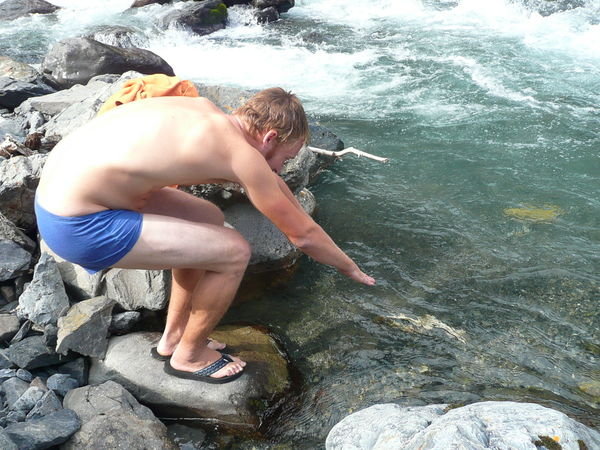 Alex jumps in a glacial river