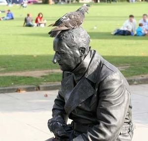 "Statue" actor with pigeons at the London Eye.