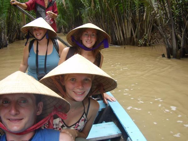 Us on a small row boat down a canal to the mekong delta