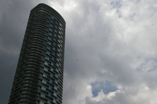 Nearby skyscraper and clouds