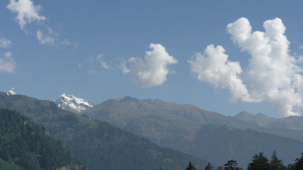 Snow peaks towering in the distance over Manali