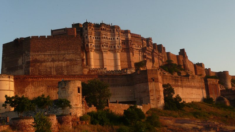 The imposing walls of Meherangarh Fort at sunset